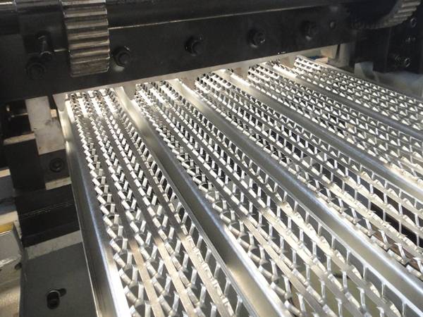 The machine is profiling the punched steel plate.