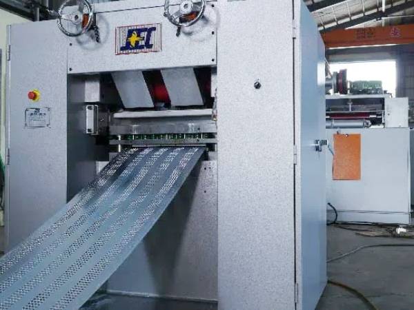 The machine is punching the steel plate for hy rib mesh production.