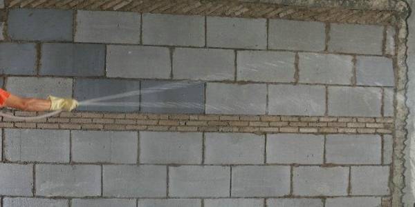 Spray and clean the wall surface with water.