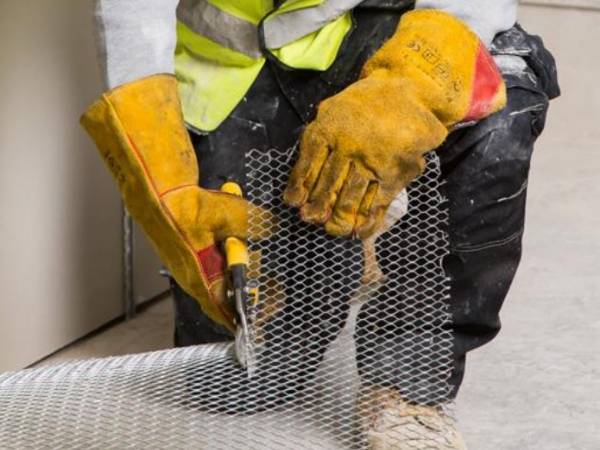 The worker is cutting the metal lath into desired size.