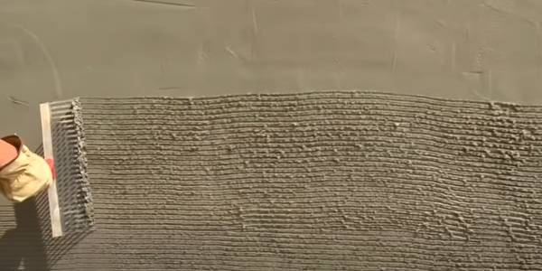 Apply the mortar onto the metal lath and then scratch the surface with a rake.