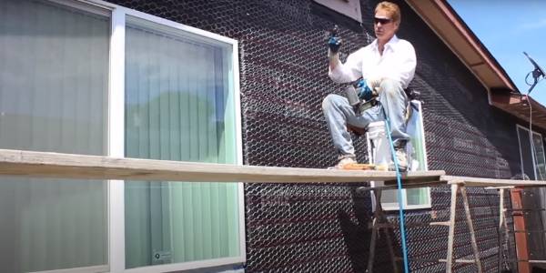 Lay 2 waterproof layers and a metal lath layer onto the wood wall surface.